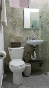 a bathroom with a toilet and a sink at Casa Aura - Center Studio - 1st Floor in Isla Mujeres