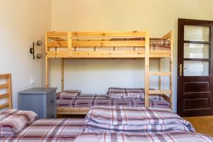 a bedroom with three bunk beds in a room at Mir i planina 
