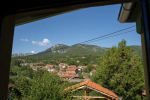a view from a window of a town with mountains at Mir i planina 