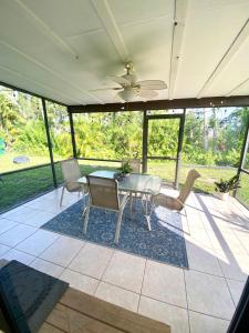 a screened in porch with a table and chairs at Cypress Retreat in Fort Myers