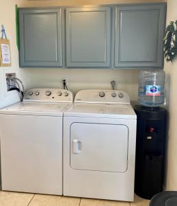 a kitchen with two white washers and a water tank at Cypress Retreat in Fort Myers