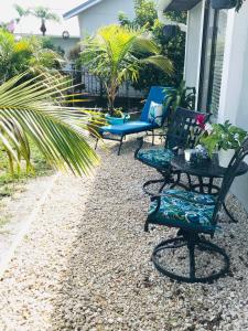 a group of chairs sitting on the side of a house at Cypress Retreat in Fort Myers