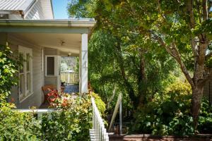 a porch of a house with flowers and trees at Brindabella in Daylesford