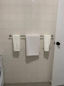 a bathroom with white towels hanging on a wall at Bribie Get away in Bongaree