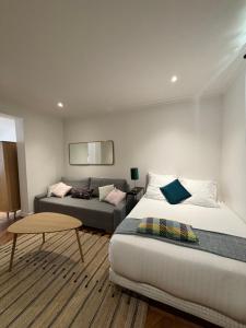 une chambre avec un lit et un canapé dans l'établissement Le Rêveur - Parking Gratuit, Wifi, RER C Choisy-le-Roi, à Choisy-le-Roi