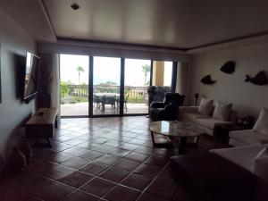 a living room with a couch and a table at delfines 204 in Cabo San Lucas