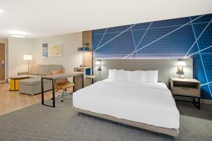 a bedroom with a large white bed and a desk at Comfort Suites Idaho Falls in Idaho Falls