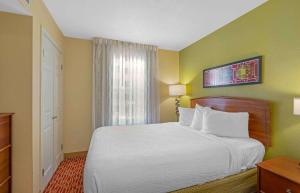a hotel room with a bed and a window at Extended Stay America Suites - Chantilly - Dulles in Chantilly