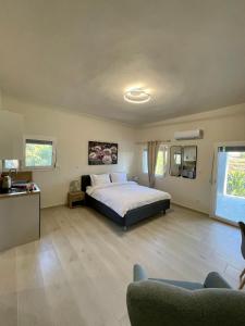 a large bedroom with a bed and a couch at Lemnos Urban Escape in Myrina