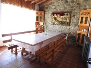 a kitchen with a table and benches in a room at La Majada del Puente in El Royo +33 photos