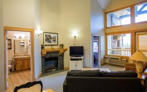 a living room with a couch and a fireplace at Cornerstone Lodge by Park Vacation Management in Fernie