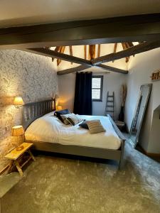 a bedroom with a large bed in a room at Ferme Marie Hélène in Ittlenheim