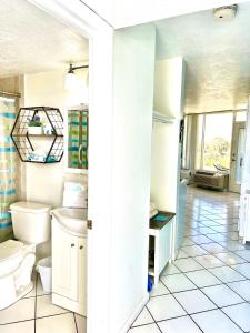 a bathroom with a toilet and a sink at Beach Happy - Ocean View at Symphony Beach Club in Ormond Beach