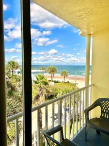 a balcony with a view of the beach and the ocean at Beach Happy - Ocean View at Symphony Beach Club in Ormond Beach