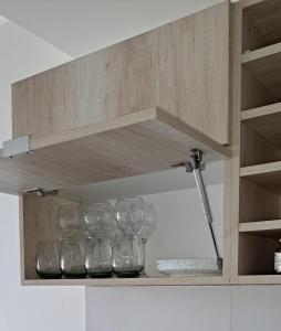 a row of wine glasses sitting on a shelf at Departamento frente al mar en Monte Hermoso in Monte Hermoso +3 photos