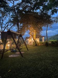 a swing set in the grass in a yard at Alpinas Montecarlo in Ostumán