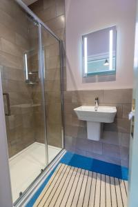 a bathroom with a shower and a sink at 2 The Winnings - Stunning Cottage on a Country Estate in Worksop