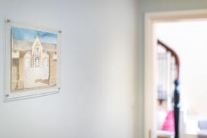 a picture of a church hanging on a wall at 2 The Winnings - Stunning Cottage on a Country Estate in Worksop