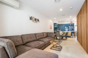 a living room with a couch and a dining room at Westend 3 bedroom Split level Townhouse Next to River in Brisbane