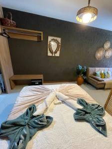 a bedroom with a bed with towels on it at Mani Milagres Studio - Gamboa Patacho in Pôrto de Pedras +33 photos