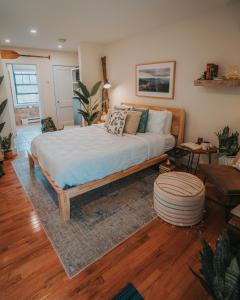 a bedroom with a bed and a living room at Willow Pond Motel in Catskill