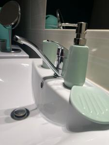 a bathroom sink with a faucet and a toilet at Veľký apartman in Karlova Ves