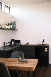 a kitchen with a wooden table and a counter top at Buller Wines in Rutherglen