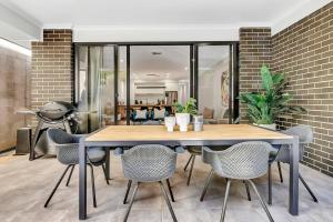 a dining room with a wooden table and chairs at 'Brightly Brompton' A Family Delight by the Park in Bowden