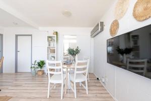 a dining room with a table and chairs at Scandi Beach Breeze Minutes from Glenelg Beach in Glenelg