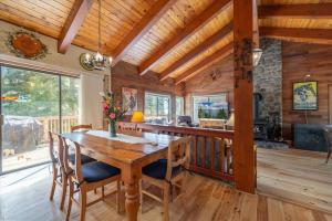 a dining room with a wooden table and chairs at Cozy Home with Lake Views Decks Hot-Tub Walk to Private HOA Beach in 5 min in Tahoe City