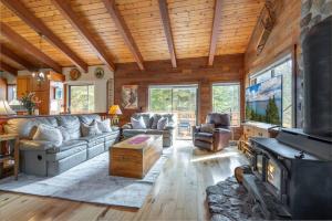 a living room with a couch and a fireplace at Cozy Home with Lake Views Decks Hot-Tub Walk to Private HOA Beach in 5 min in Tahoe City
