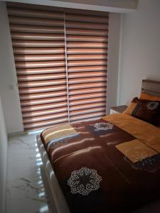 a bedroom with a large bed and a large window at appartement in mahmutlar alanya in Alanya