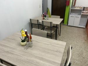 un comedor con 2 mesas y sillas con flores en SEVEN DAYS HOTEL B&B, en San Pedro Sula
