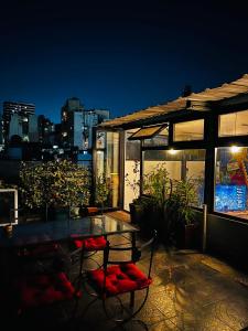 a table and chairs on a patio at night at Casa Sumaq in Buenos Aires