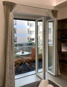a room with a sliding glass door leading to a balcony at Ecclesia Domus Vatican Inn in Rome