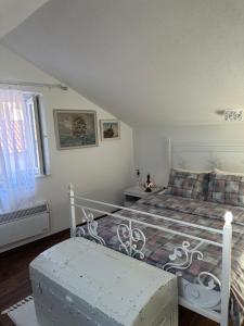 a bedroom with a bed and a bench in it at Apartman Senka in Budva