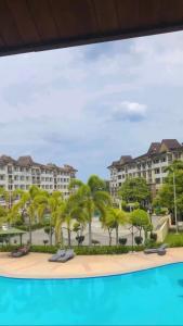 a view of a resort with palm trees and buildings at Alles One Oasis Condo Davao Near SM Mall with Wifi in Davao City