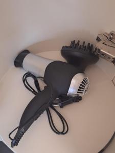 a blow dryer is sitting on a table at Easy Host Porto in Porto
