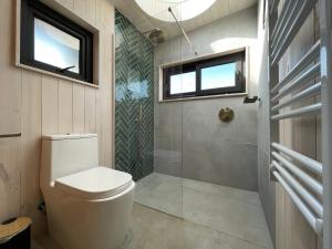 a bathroom with a toilet and a shower at Chackra Centinela in Matanzas +46 photos