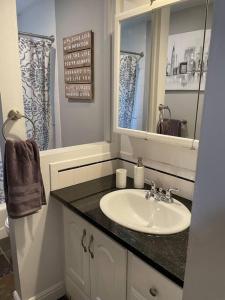 a bathroom with a sink and a mirror at Spacious 4 bdr w/ Game Room 5 min Drive to College in Boulder