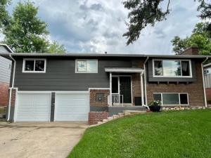 a home with a gray house with a driveway at Spacious 4 bdr w/ Game Room 5 min Drive to College in Boulder