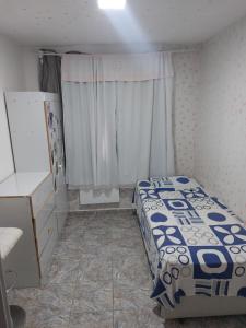 a small bedroom with a bed and a window at Apartamento Rio Centro in Rio de Janeiro