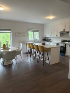a kitchen with a table and chairs in a room at Stylish 5-Bedroom Retreat Near Port Dover and Turkey Point Beach in Simcoe