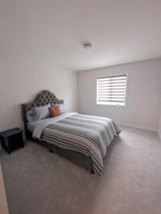 a bedroom with a bed and a window at Stylish 5-Bedroom Retreat Near Port Dover and Turkey Point Beach in Simcoe