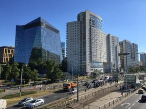 a city with tall buildings and a street with cars at Westfield Arkadia P&O Serviced Apartments in Warsaw