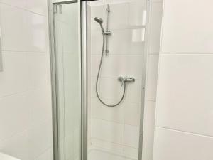 a shower in a bathroom with a glass door at 100 m2 Apartment - Free Parking- 15 min to Center in Vienna