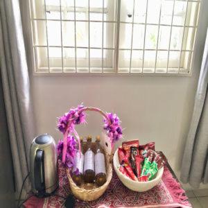 a table with two baskets of candy on a table at Basari Guest House in Lundu