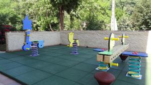 a playground with play equipment on a tiled floor at Hotel Intriago I & II in Intriago
