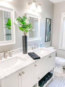 a bathroom with two sinks and a vase with a plant at Arrowhead Riverfront Kayaks/Patio 30 Min to ND! in Bristol +51 photos