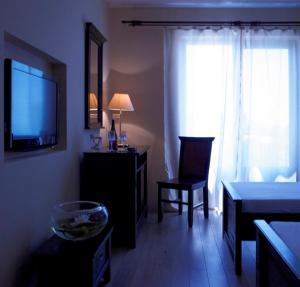 a living room with a television and a table and chair at Vila Caviar in Sulina
